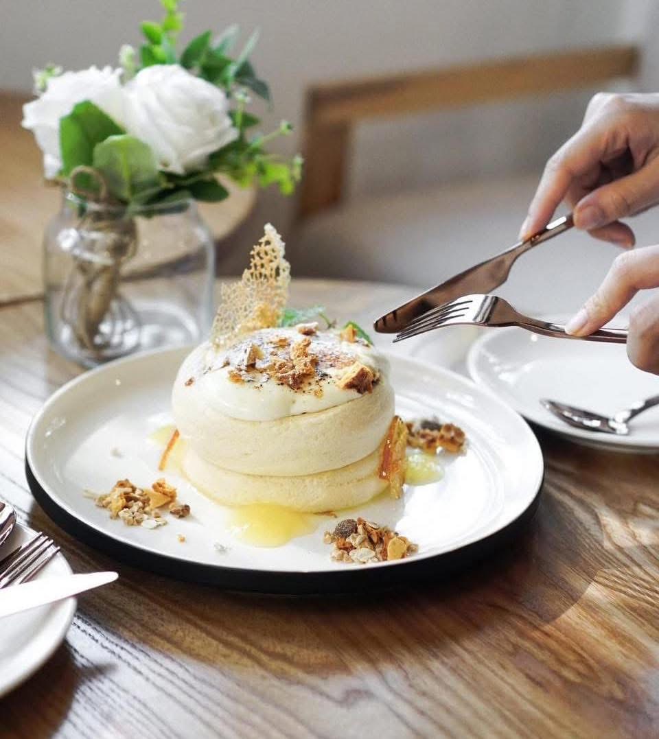 Ryoku souffle pancake plated with cream and fruit