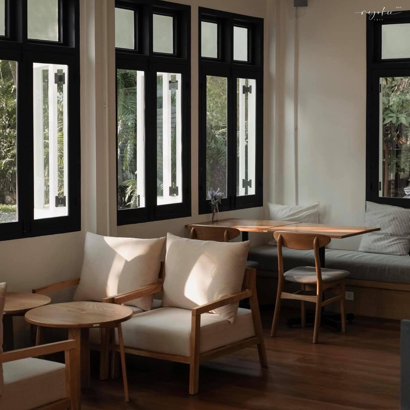 Ryoku lounge corner with black-framed windows and wood seating